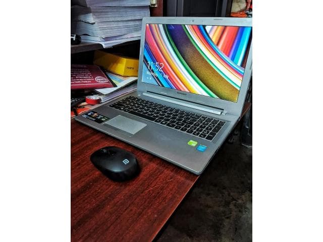 Laptop with new battery and wireless mouse.